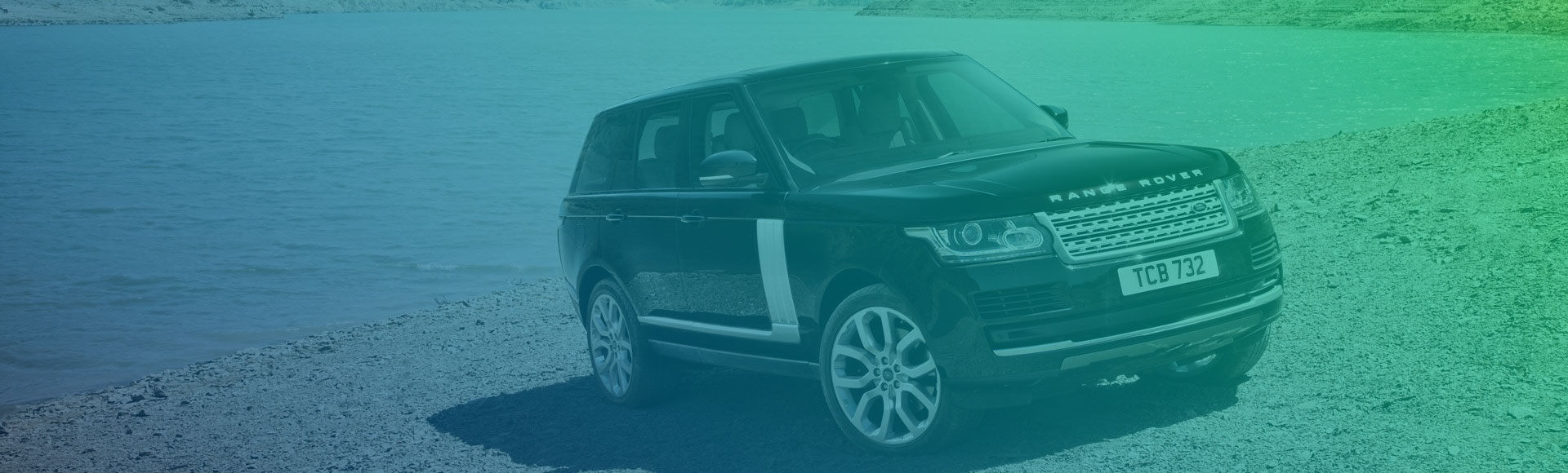 A land Rover parked near the lake