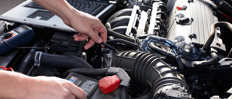 Mechanic using diagnostic tools to check the vehicle's condition
